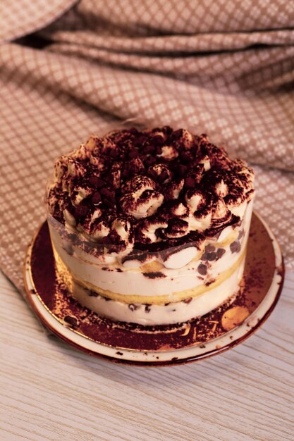 Board with delicious cake on table