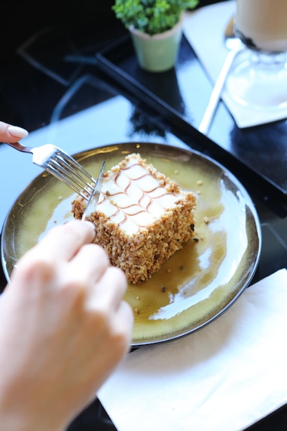 Board with delicious cake on table