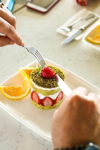 Board with delicious cake on table