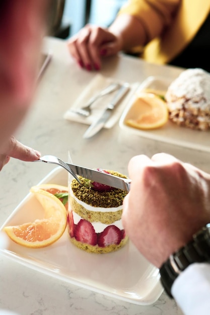 Board with delicious cake on table