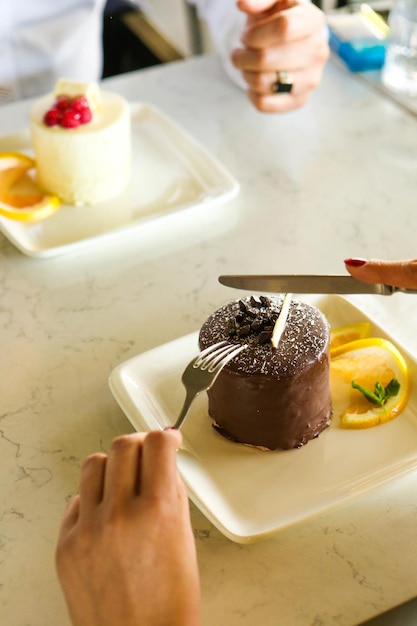 Board with delicious cake on table