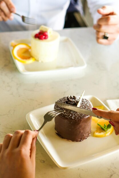 Board with delicious cake on table