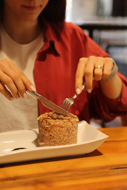 Board with delicious cake on table