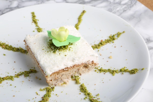 Board with delicious cake on table