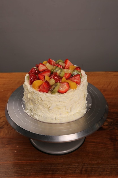 Board with delicious cake on table