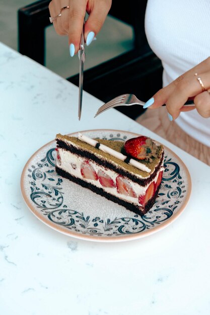 Board with delicious cake on table