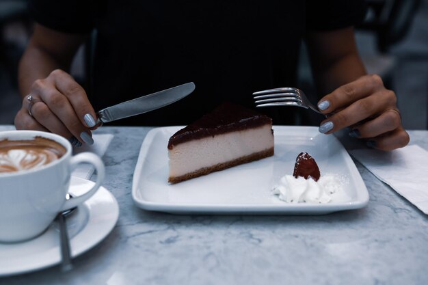 Board with delicious cake on table