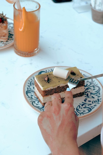 Board with delicious cake on table