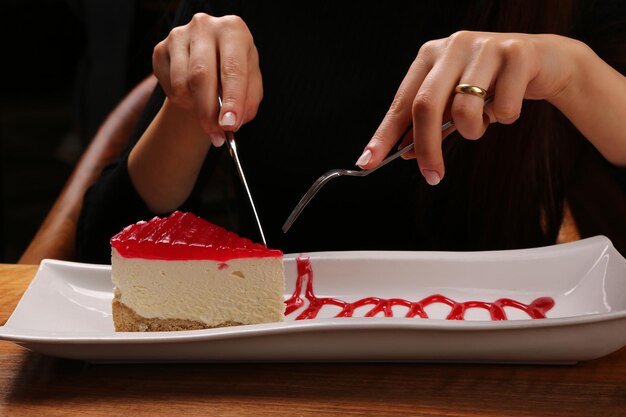 Board with delicious cake on table