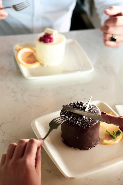 Board with delicious cake on table