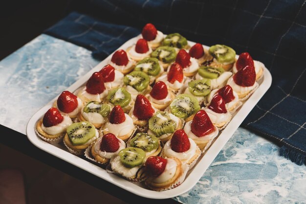 Board with delicious cake on table