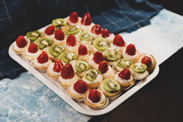 Board with delicious cake on table