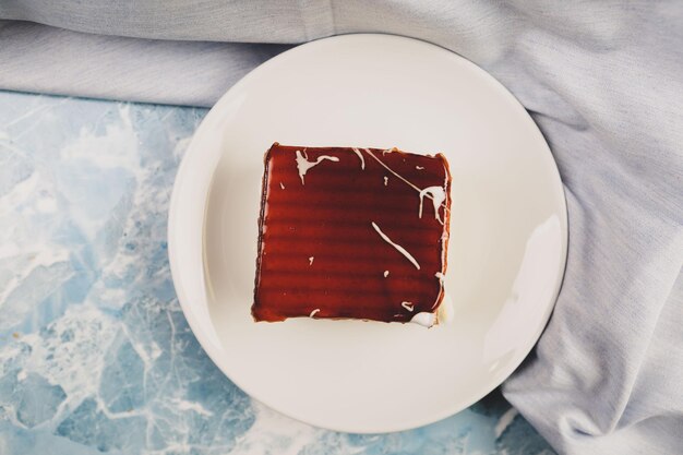 Board with delicious cake on table