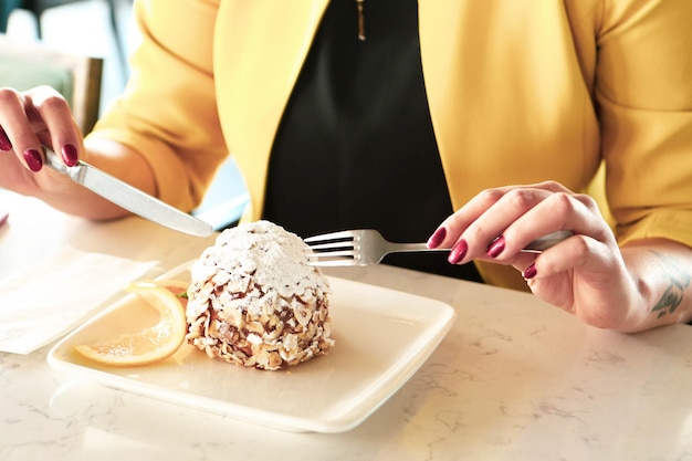 Board with delicious cake on table