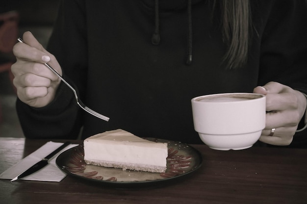 Board with delicious cake on table