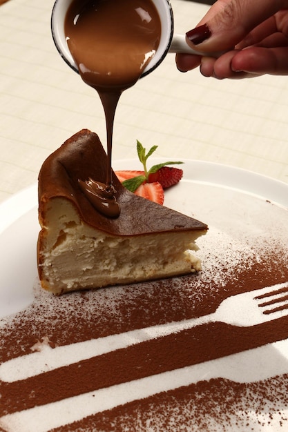 Board with delicious cake on table