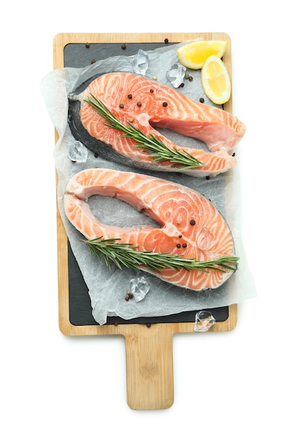 Board with fresh raw salmon isolated on white background