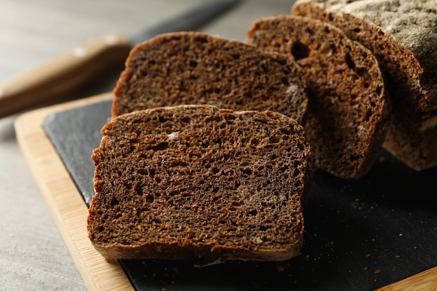 Board with fresh rye bread, close up