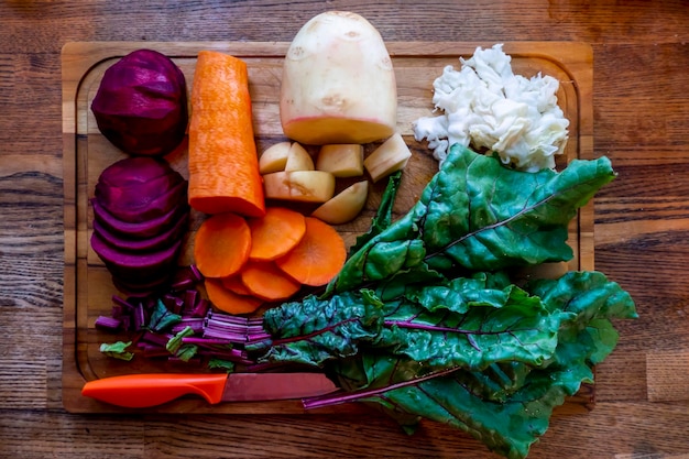 Photo board with ingredients for preparing tasty borscht on white background