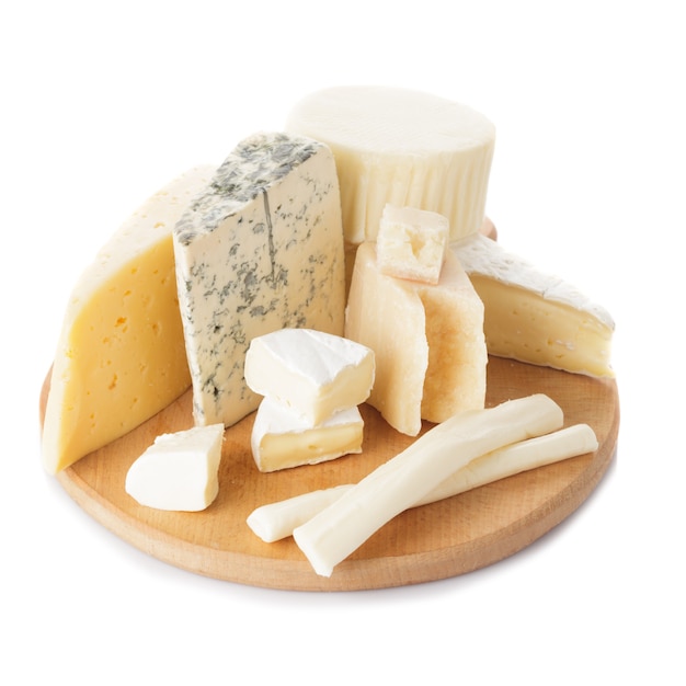 Board with pieces of various types of cheese on the board