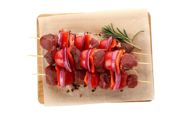 Board with raw shish kebab isolated on white