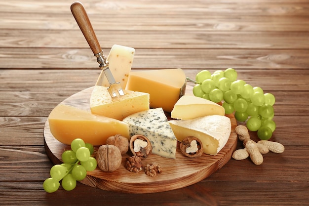 木製の背景にチーズの様々なボード