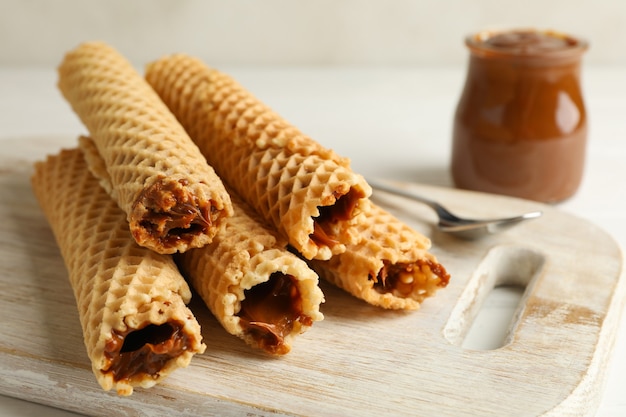 Photo board with wafer rolls with condensed milk, close up