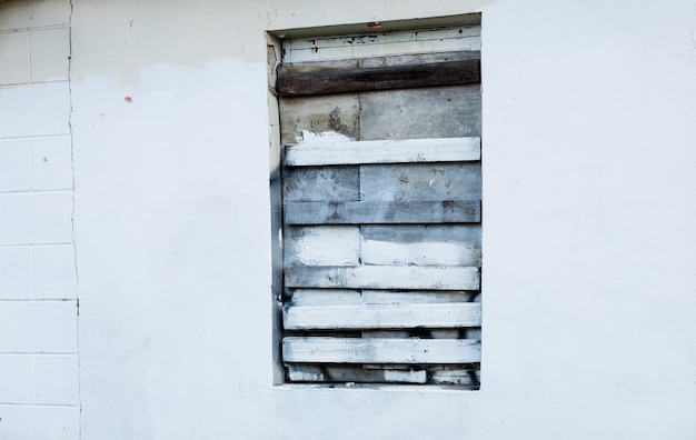 Photo boarded up window in the old house