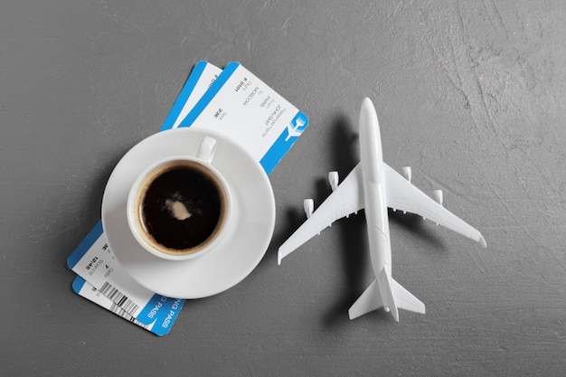 Boarding pass and toy airplane on table top view