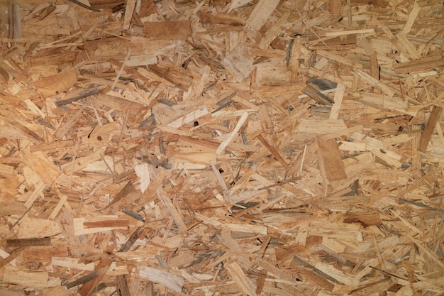 Boards OSB wood texture background. Wooden shavings compressed wall pattern.