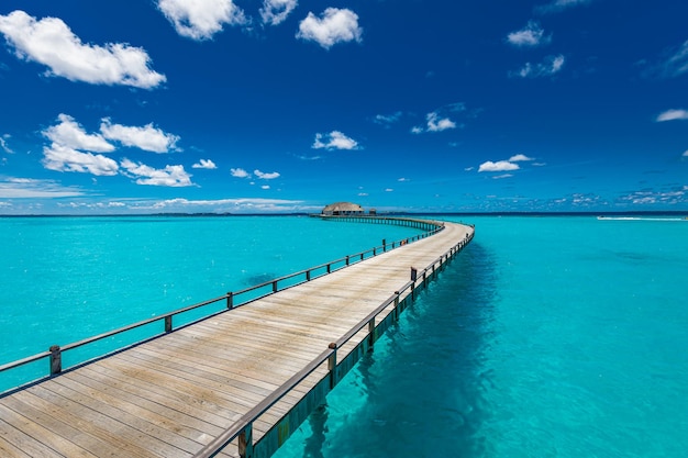 Boardwalk to paradise, ocean lagoon blue sunny sky. luxury water villa wooden pier, summer vacation