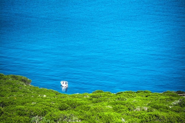 Boat alone in the sea in Porto Conte bay Sardinia