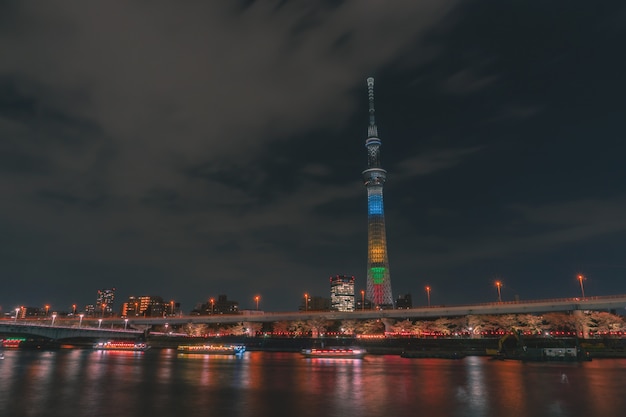 Boat are traveling in Sumida river with Tokyo Skytree