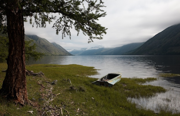 Boat on the bank of mountain lake