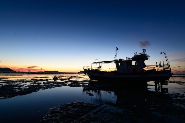 Photo a boat on the beach and sunrise