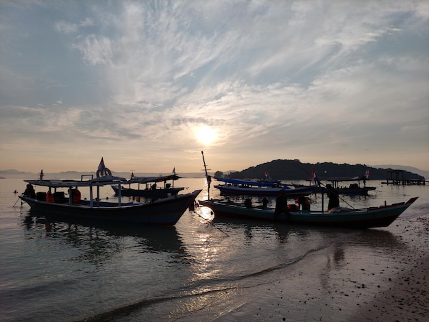 Boat on beach at sunrise