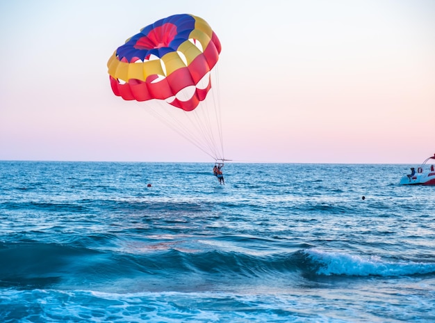 Boat dragging couples with clourfull parachute