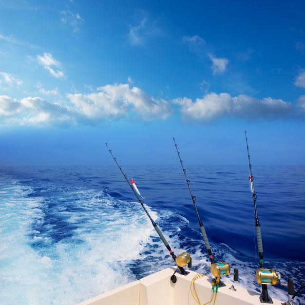 boat fishing trolling in deep blue ocean offshore