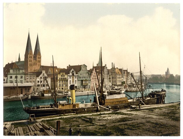 a boat is docked in front of a building with a church in the background