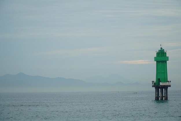 A boat is in the water with a mountain in the background.