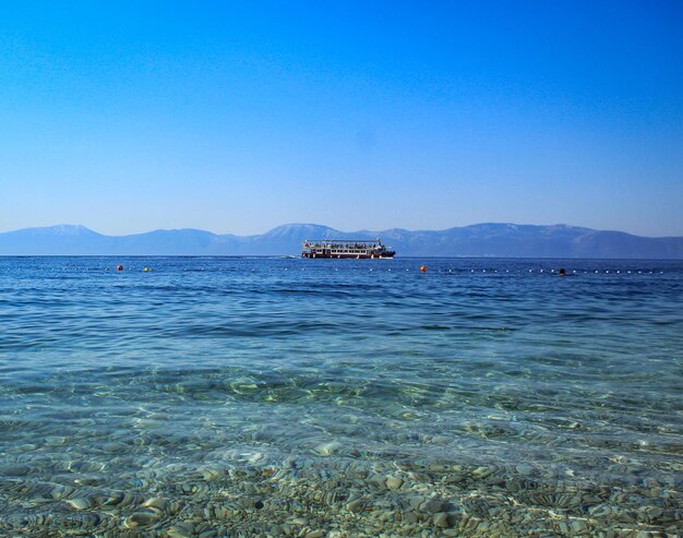 Photo a boat is in the water with mountains in the background