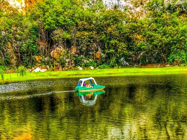 Boat in lake against trees