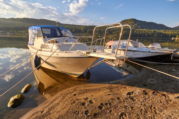 Boat on lake at background of sunset in a clear summer day.