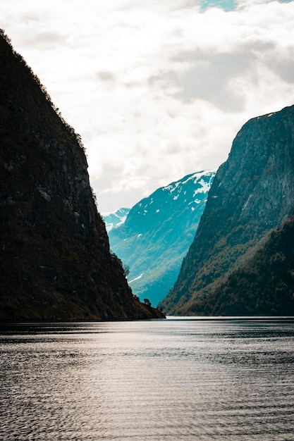 A boat on a lake with mountains in the background