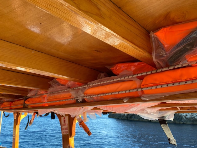 Boat lifesaving equipment life jacketslots of bright orange color It is hung under the roof