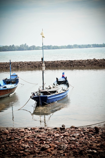 boat moored in lake against sky