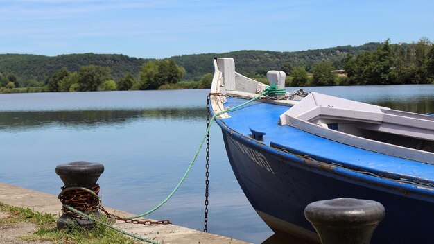 Boat moored in lake against sky