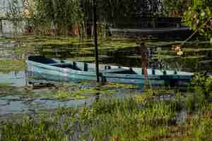 Photo boat moored near the river bank wooden fishing boat in the village