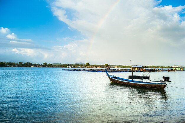 Boat moored in river against sky