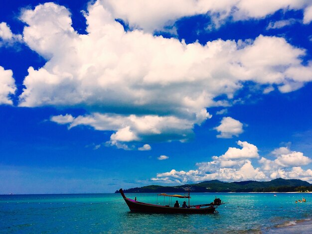 Boat moored on sea against sky